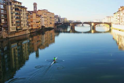 Wandering along the Ponte Vecchio, with a rower in the River Arno.