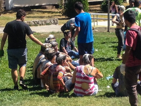 Freshmen being covered in flour, eggs, vinegar, mustard, and other non-traditional personal hygiene products.